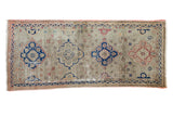 Vintage distressed Oushak runner with dusty grey field, contrasting navy and terra cotta motifs.