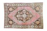 Expressive deep rose vintage Oushak rug with charcoal bronze medallion and faded tangerine, 4'6