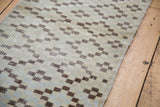 Geometric checker and diamond pattern with distressed texture on vintage Oushak runner.