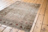 European-style Kaisery rug, distressed pile with faded red flowers and intricate vines.