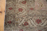 Distressed corner of a vintage Kaisery rug, intricate European floral motifs and vines.