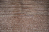 Distressed Oushak rug's natural undyed wool pile with visible abrash texture.