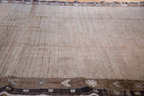 Distressed Oushak carpet displaying textured natural wool pile and soft rose border motifs.