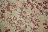 Distressed pile of a vintage Oushak rug with rosey cinnabar blossoming vines.