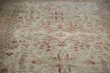 Distressed vintage Oushak carpet with faded rose vines and tendrils on ivory.
