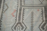 Distressed Jijim rug featuring silvery sea foam green geometric lattice and linear floral motifs.