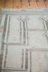 Distressed silvery sea foam green Jijim rug with linear plant and lattice motifs.