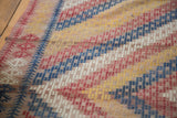 Hand-woven vintage Jijim carpet, geometric patterns of denim blue, red, ivory, gold.