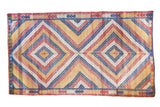 Colorful vintage Jijim carpet, dual concentric diamond pattern, in blue, red, gold, ivory.