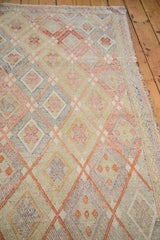 Softened cinnabar red, beige, and pale hues in the vintage Jajim's lattice diamond pattern.