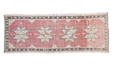 Distressed Jijim runner with faded cranberry field and bold geometric star patterns.