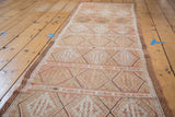 Hand-woven vintage Jijim runner showcasing repeating diamond motifs in soft peach tones.
