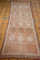 Soft muted color palette and repeating geometric diamond pattern on vintage Jijim runner.