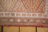 Jijim runner's hand-woven lower edge, displaying horizontal geometric bands and soft reddish fringe.