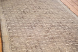 Distressed vintage Jijim runner, close-up of intricate geometric patterns in muted ivory and brown.