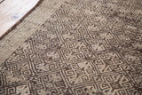 Distressed Jijim runner's intricate geometric pattern in charcoal, ivory, silver, and brown.