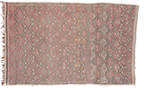 Pale vintage Jajim rug featuring geometric diamond patterns in charcoal, red, cream, and yellow.