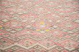 Intricate, tightly woven geometric pattern, faded red, charcoal, tangerine on vintage Jajim rug.