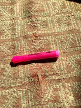 Vintage Jijim carpet detail: pink highlighter emphasizing loose fiber wear.