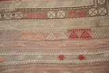 Vintage Jijim hand-woven rug showcasing geometric patterns in faded cinnabar and ivory.