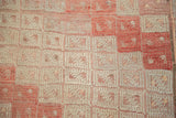 Close detail of vintage Jijim rug's textured geometric guls in ivory, silver, faded cinnabar.