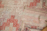 Vintage Jijim carpet's end with geometric bands, fringed edge, and faded ivory, silver, and cinnabar tones.