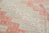 Intricate flat-weave texture of the vintage Jijim carpet, featuring faded cinnabar and ivory guls.