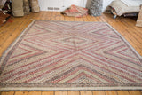 Intricate concentric diamond patterns on a vintage Jijim rug corner.