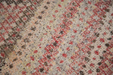Handwoven texture of Vintage Jijim carpet featuring intricate geometric patterns in red, brown, and soft tones.
