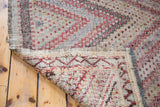 Vintage 1960s Jijim rug showing intricate red and blue geometric pattern and hand-woven foundation.