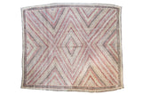 Vintage Jijim hand woven rug with geometric concentric diamond design in soft red, blue, and cream.
