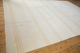 Vintage hand-woven kilim carpet featuring a modern ivory field and subtle pale tan vertical stripes.