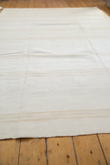 Subtle ivory and light beige stripe pattern on a modern hand-woven kilim flatweave.