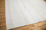 Upcycled hand-woven kilim with ivory, near white, and silver stripe pattern.