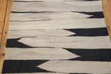 Black and natural beige Southwestern hand-woven Kilim rug with jagged stripes.