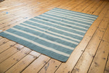 New hand woven Kilim rug, featuring striated sky blue and ivory stripes.