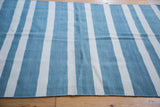 Striated sky blue and ivory vertical pattern on a hand woven Kilim rug.