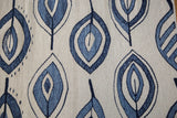 Jean blue and deep denim flayed leaf motif on the new Kilim rug's ivory field.