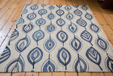 Expressive flayed flower and leaf motifs in jean blue on an ivory New Kilim rug.