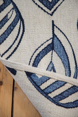 New Kilim rug construction showing ivory flatweave and blue flayed leaf motif.