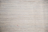 Detailed handwoven texture of a New Kilim rug, featuring varying ivory, grey, and silver shades.
