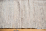 Edge of the new Kilim rug, displaying its unique textured weave of ivory, grey, and silver.
