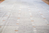 Unique striped block pattern on the subtle gray textured flatweave of a New Kilim rug.
