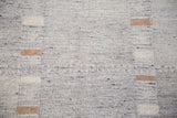 Textured gray weave of the new Kilim rug, featuring tan and ivory striped blocks.