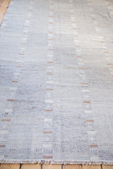 Striped gray Kilim rug's flatweave texture and soft, natural fringe.