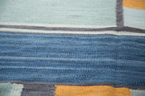 Abstract hand-woven kilim texture with denim blue, dusty powder blue, charcoal, and saffron geometric bands.