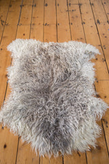 Curly angora wool throw featuring natural blended grey and off-white tones.