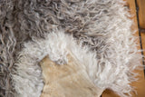 Fluffy angora wool in natural gray and white, with a smooth tan leather underside.