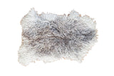Angora throw rug with fluffy curly texture in mottled white and grey.