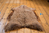 Fluffy Angora wool throw, showing the curly natural brown and tan wool texture.